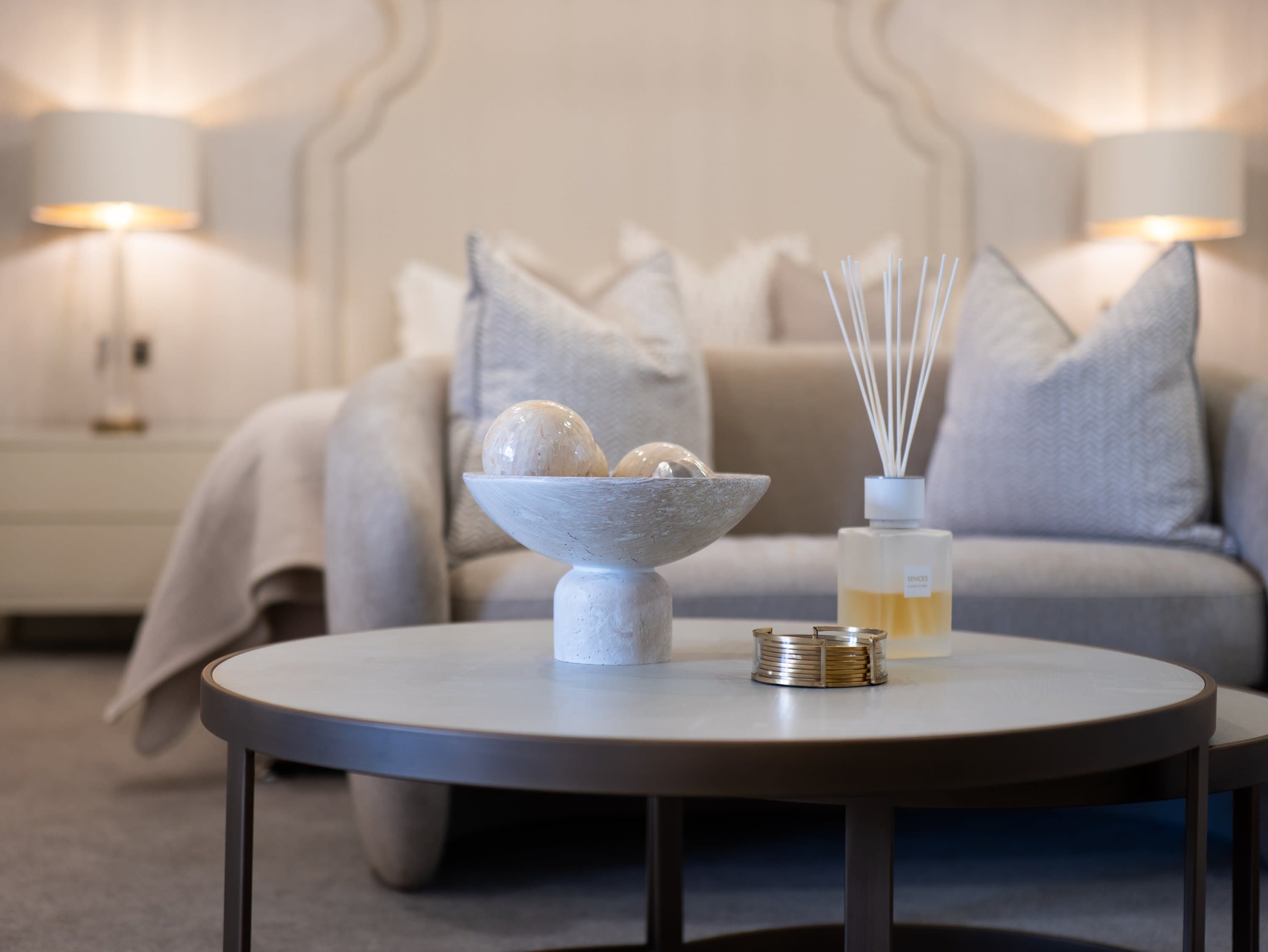 Merrydale Manor suite interior with styled coffee table and luxury sofa seating area in soft focus