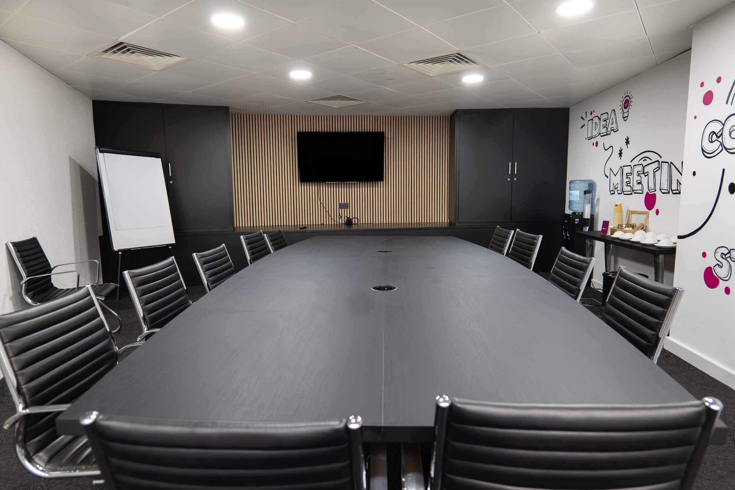Genesis Centre boardroom with acoustic timber slat feature wall and wall-mounted TV, Birchwood Warrington