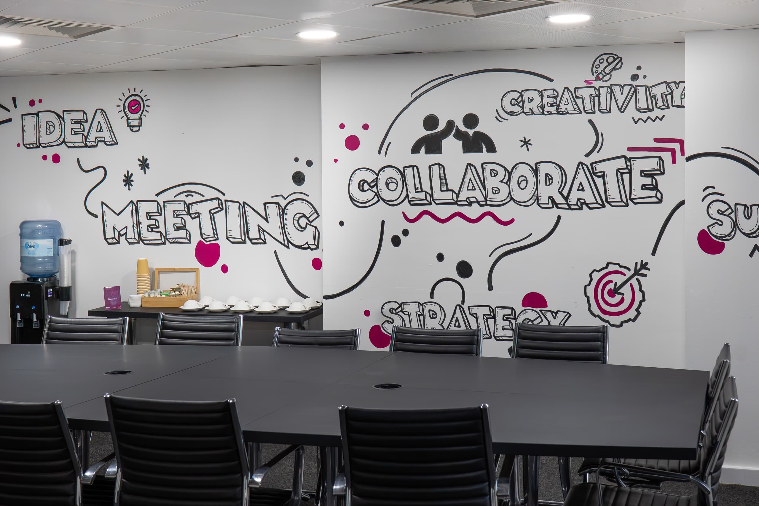 Conference room at Genesis Centre featuring IDEA COLLABORATE branded mural and modular seating, Birchwood Warrington