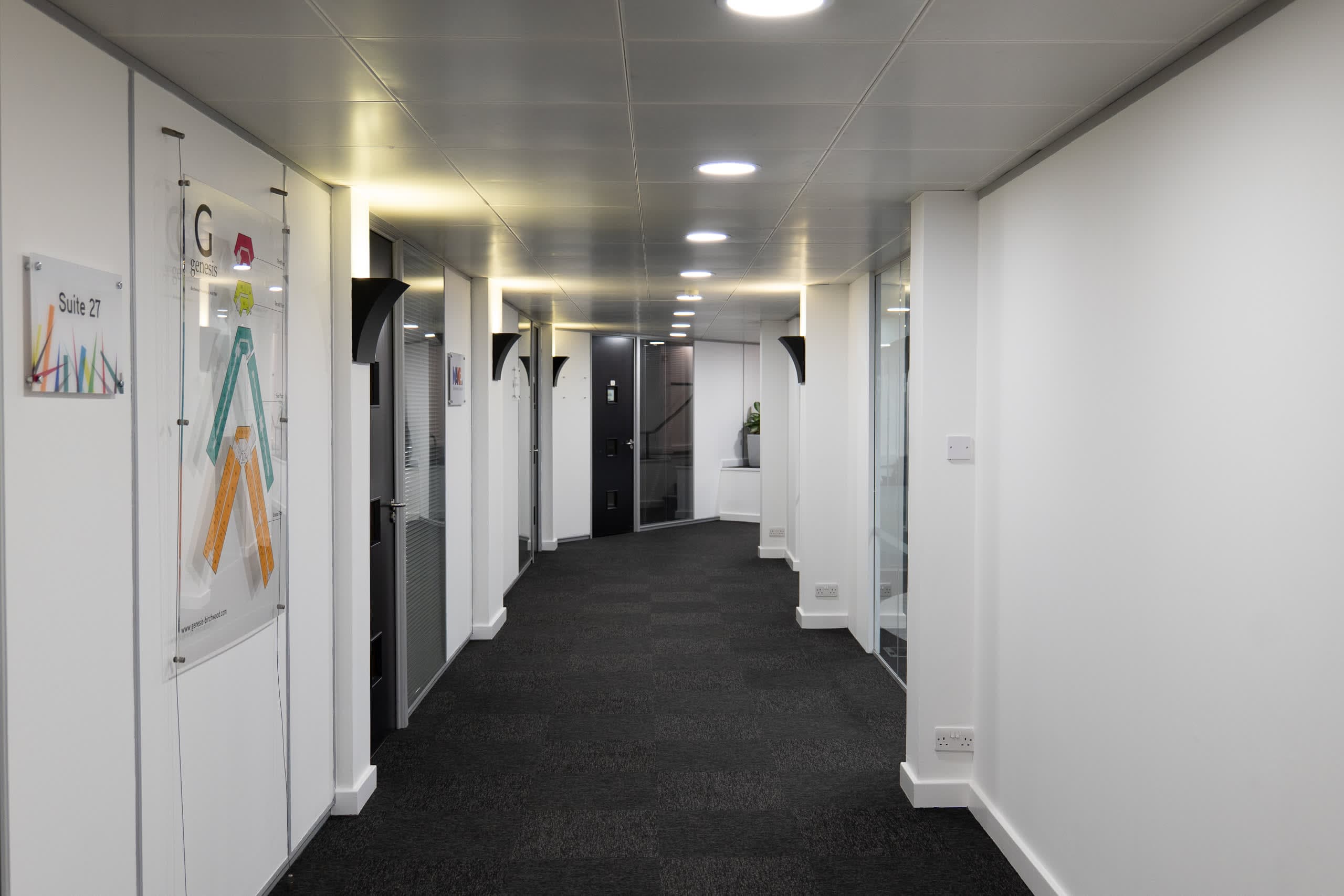 Main architectural hallway perspective at Genesis Centre with branded signage and clean finishes, Birchwood Warrington