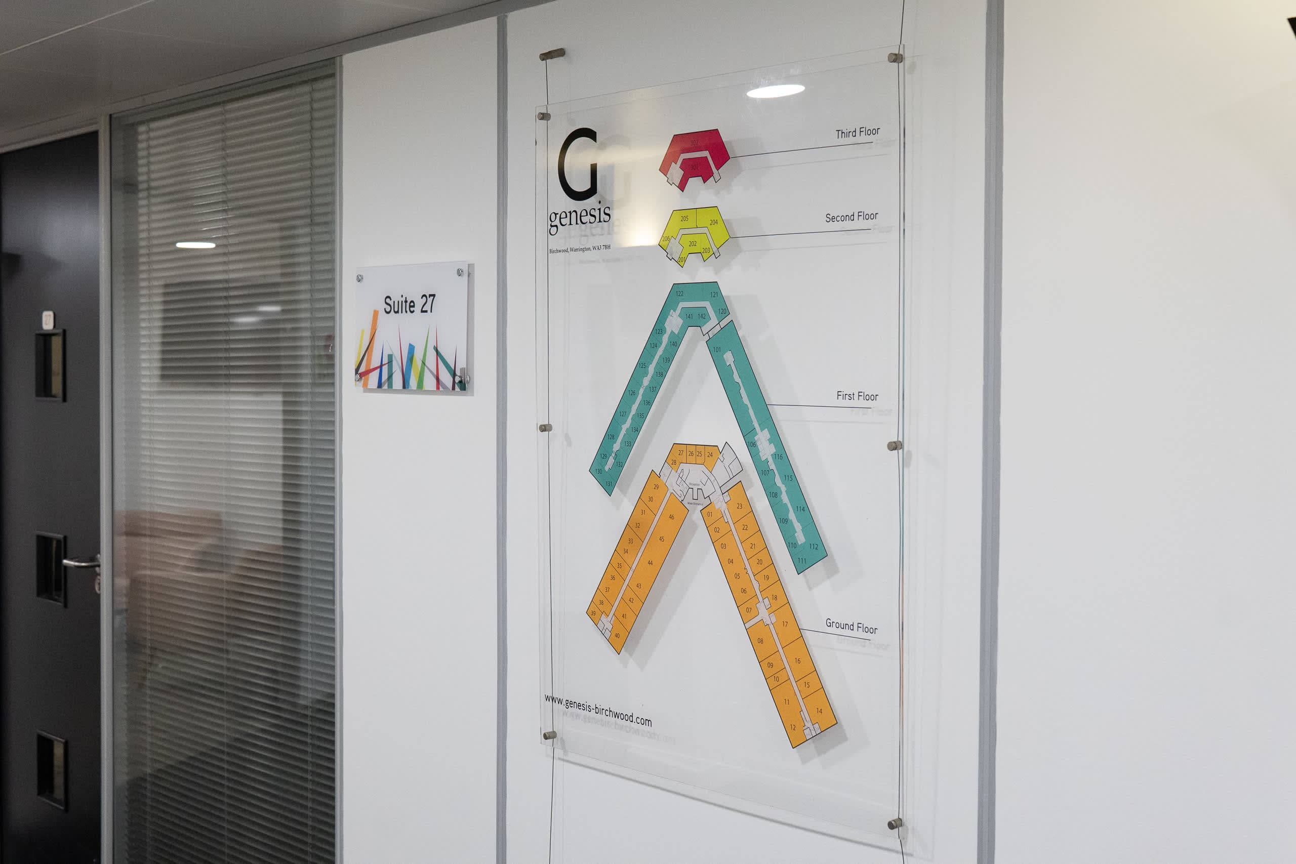 Wayfinding signage and floorplan display in the main corridor at Genesis Centre, Birchwood Warrington