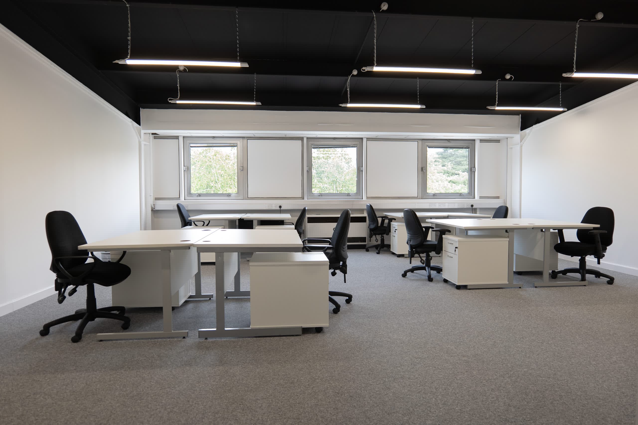 Grade A open-plan office at Genesis Centre with contemporary exposed dark ceiling and full workstation layout — view A, Birchwood Warrington