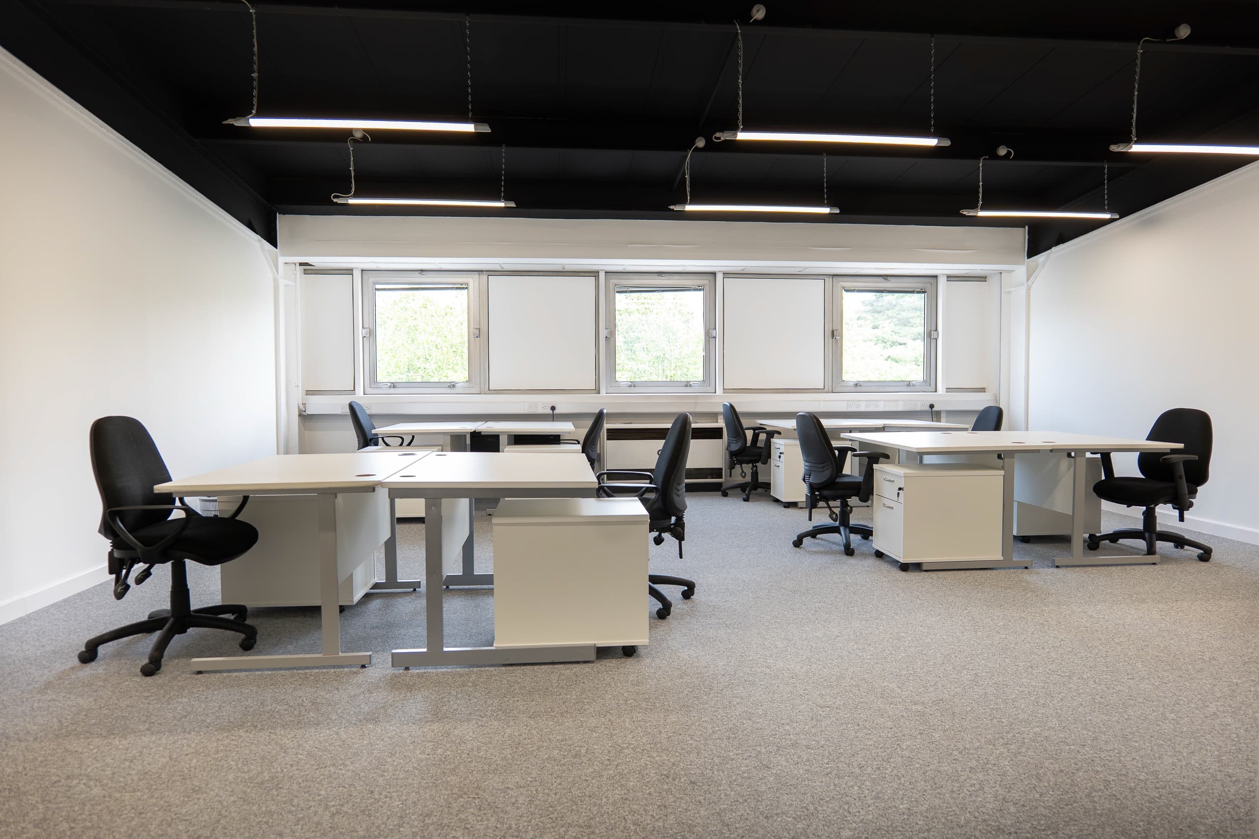 Grade A open-plan office at Genesis Centre — view B showing full floor depth and LED strip lighting, Birchwood Warrington