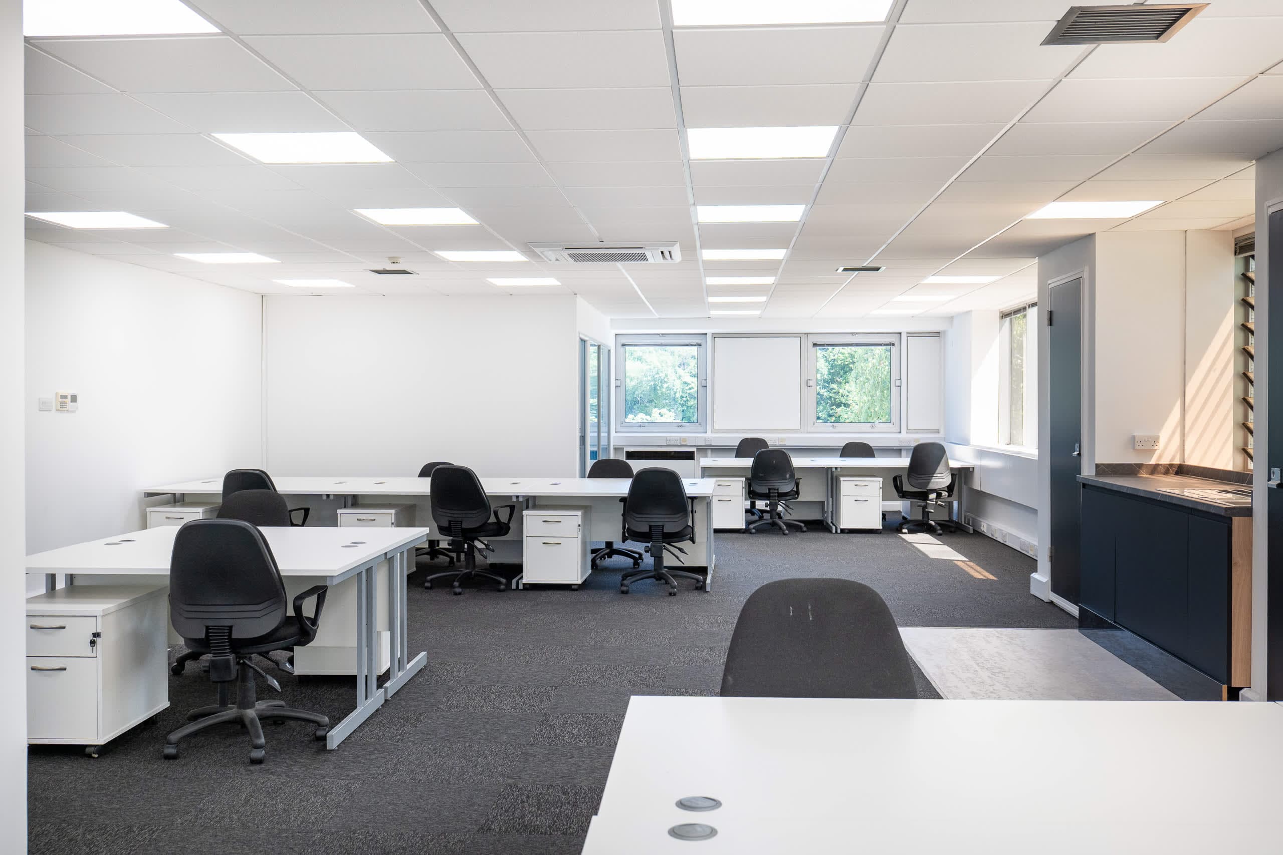 Spacious open-plan office suite at Genesis Centre with 10+ workstations and garden-facing windows — view B, Birchwood Warrington