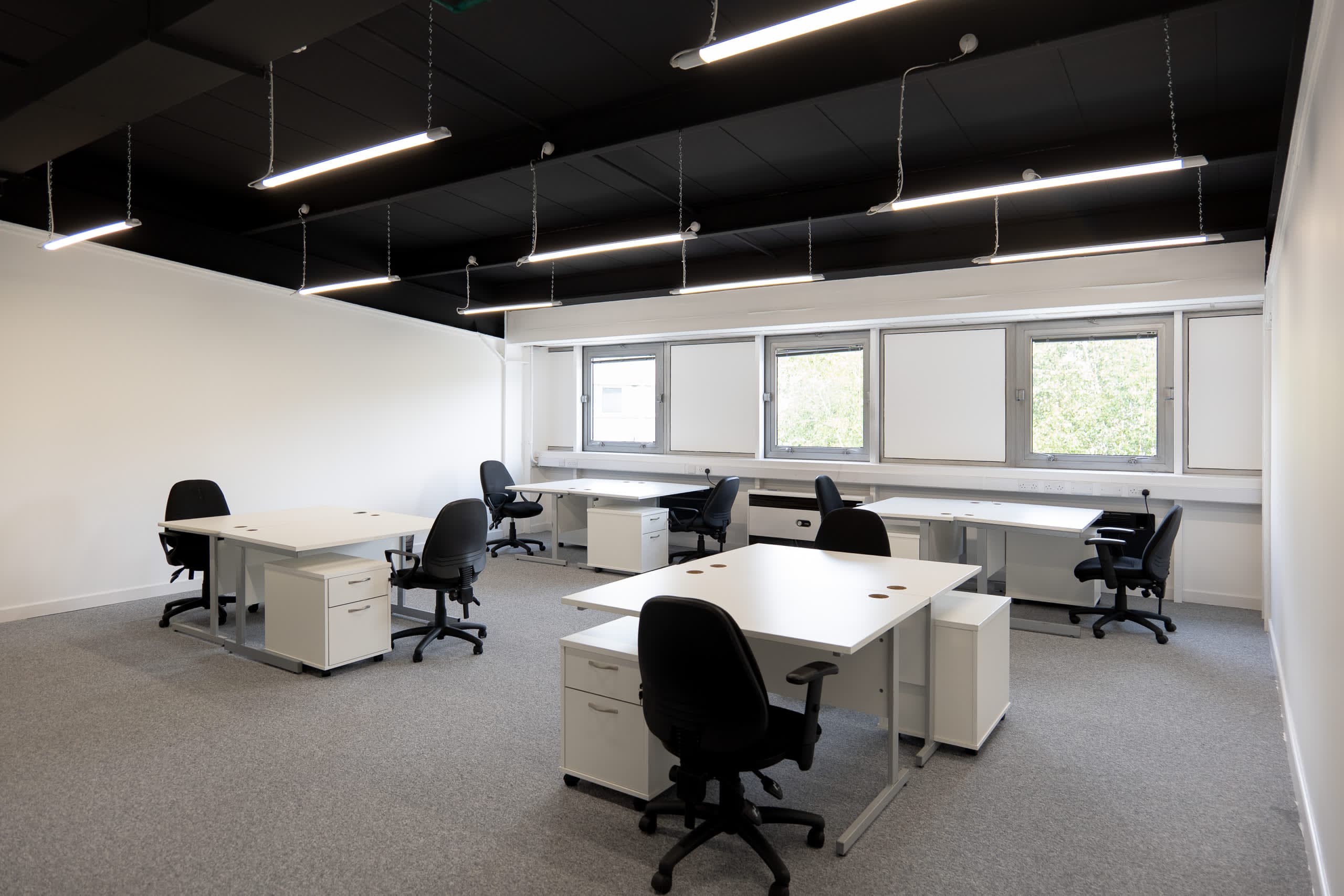 High-end private office at Genesis Centre with feature black pendant lighting and dual-aspect windows, Birchwood Warrington