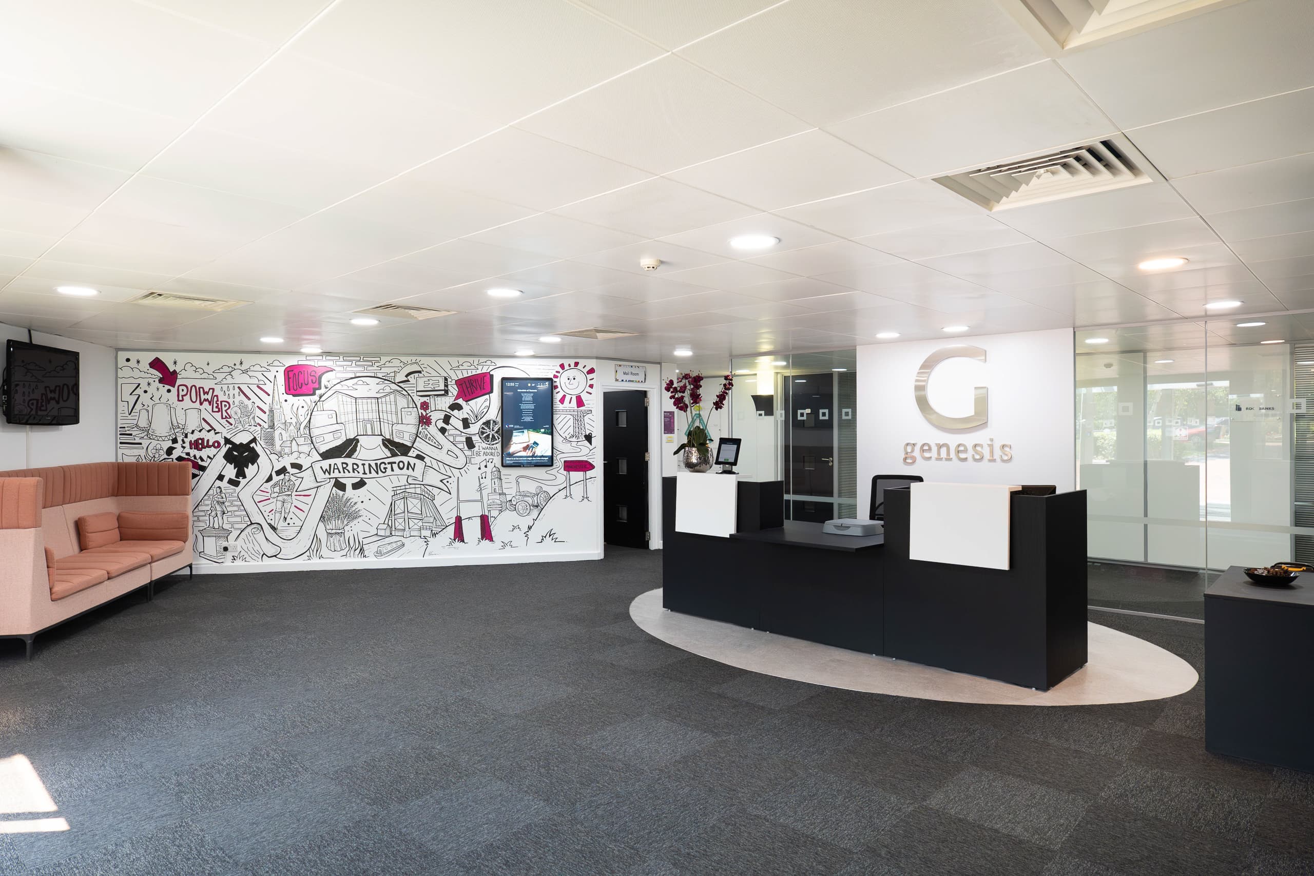 Genesis Centre Birchwood Warrington — main reception lobby overview with branded murals and natural light