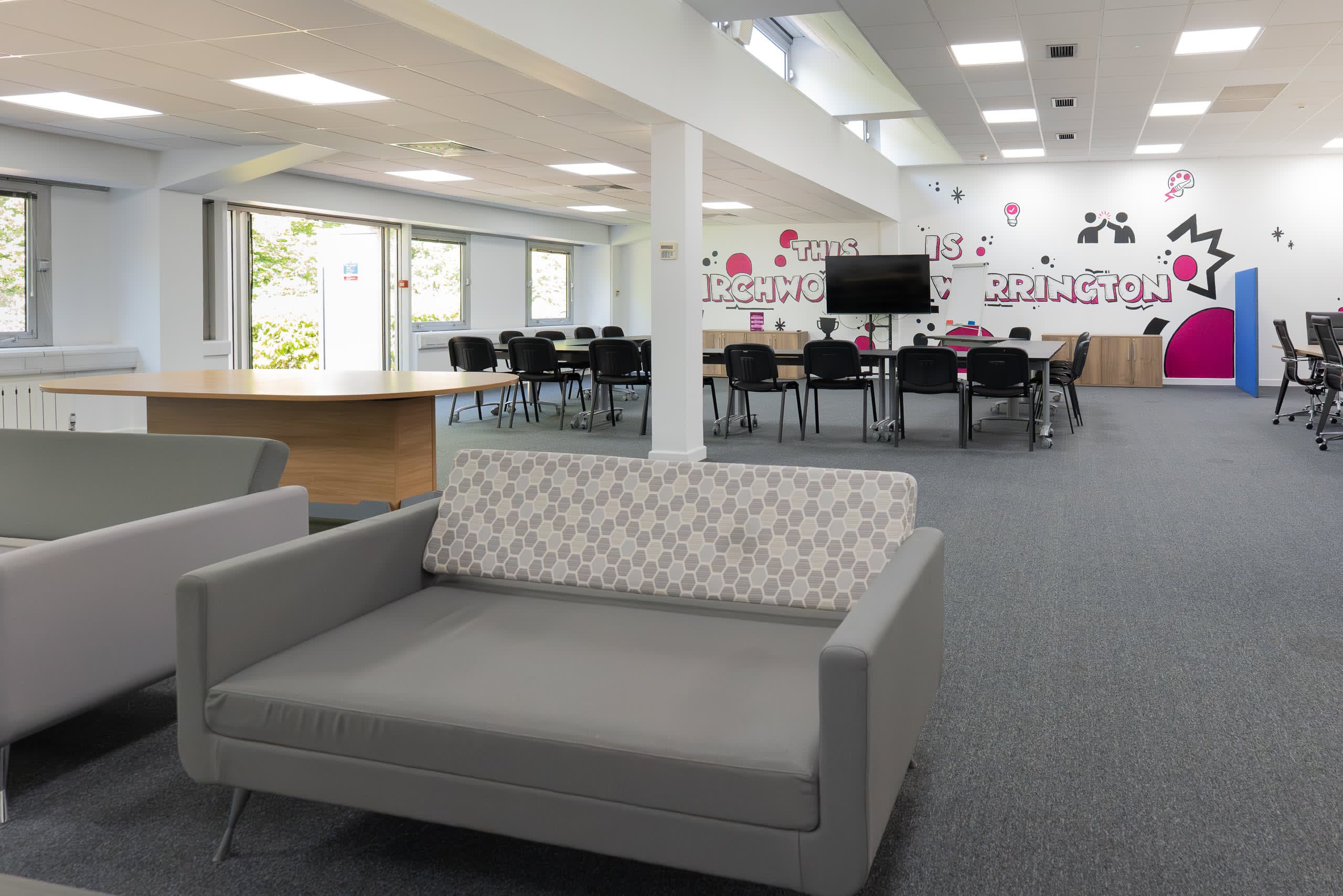 Wide view of the Genesis Centre training room with THIS IS BIRCHWOOD WARRINGTON regional identity mural, Birchwood Warrington