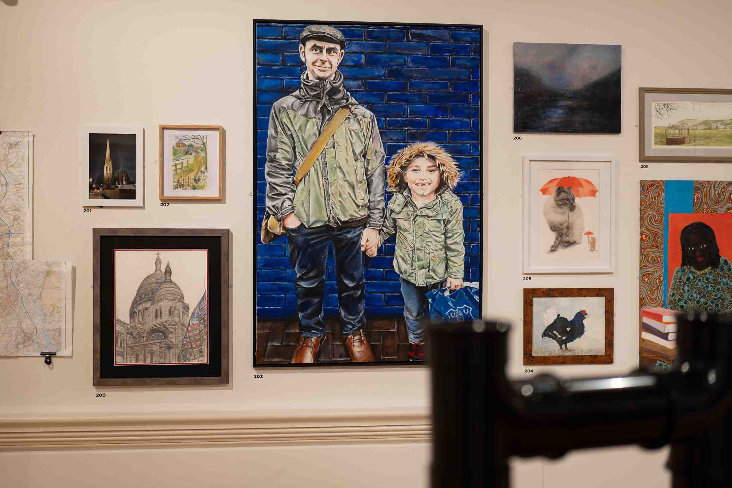 Harris Museum Open Exhibition 2026 — large figurative portrait painting of a father and child against a blue brick wall