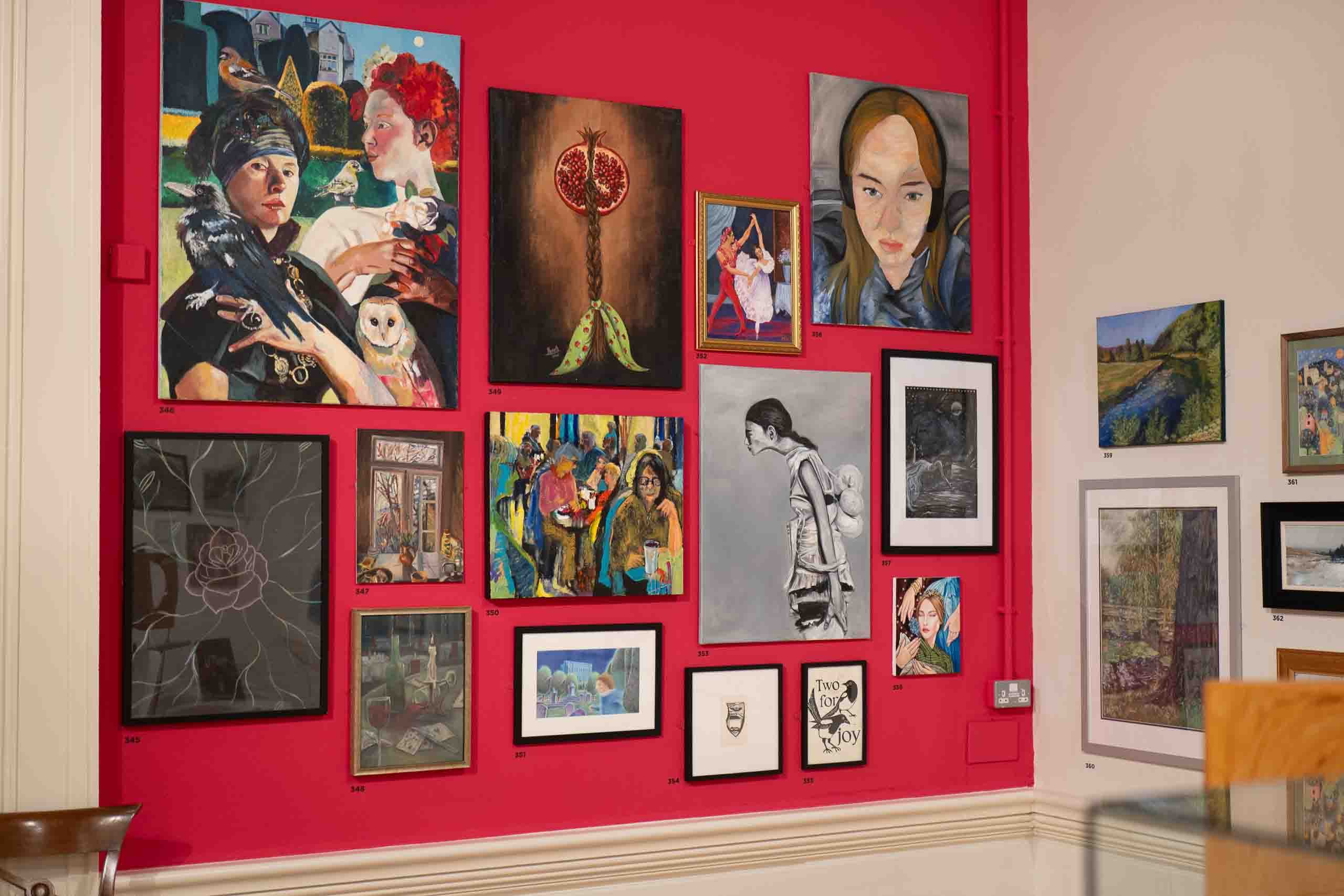 Harris Museum Open Exhibition 2026 — red feature wall section displaying bold figurative and portrait paintings in varied styles and scales