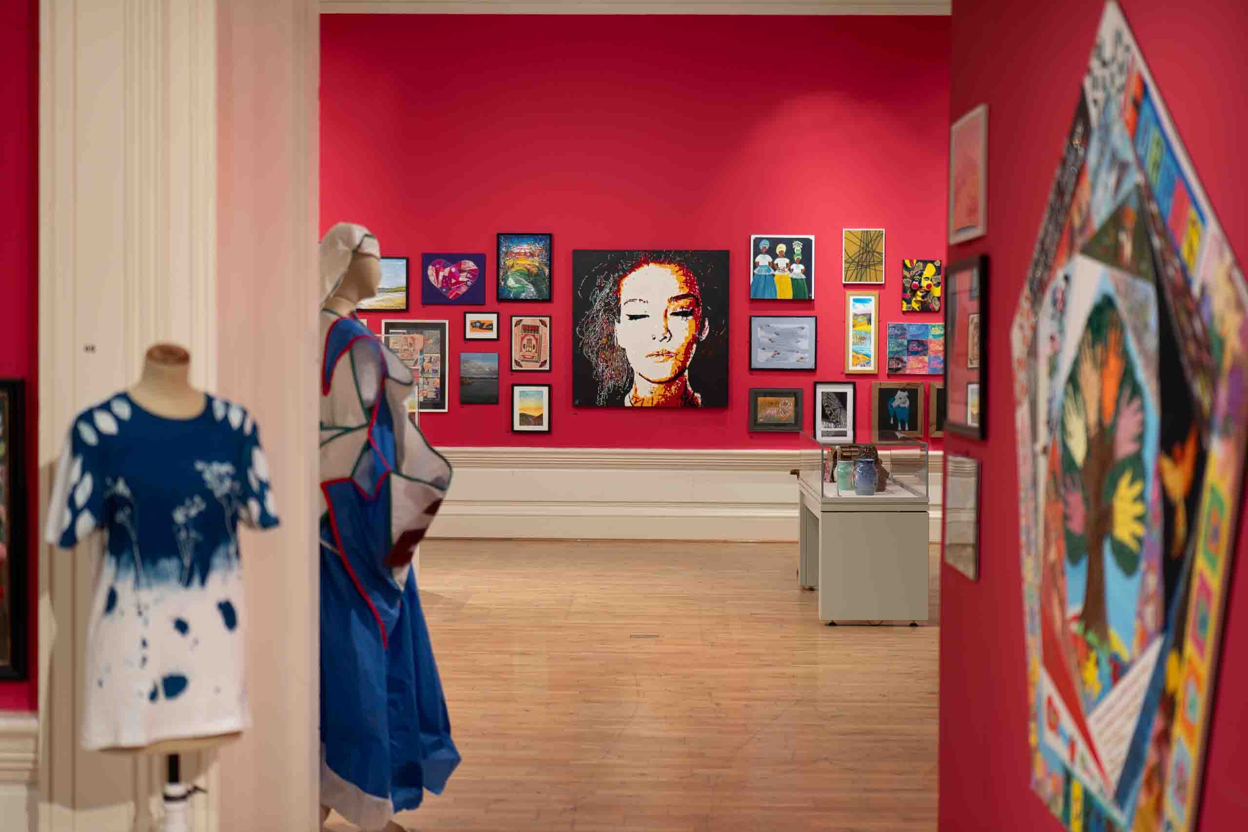 Harris Museum Open Exhibition 2026 — gallery entrance view with mannequin wearing blue and white tie-dye garment, large portrait visible through doorway