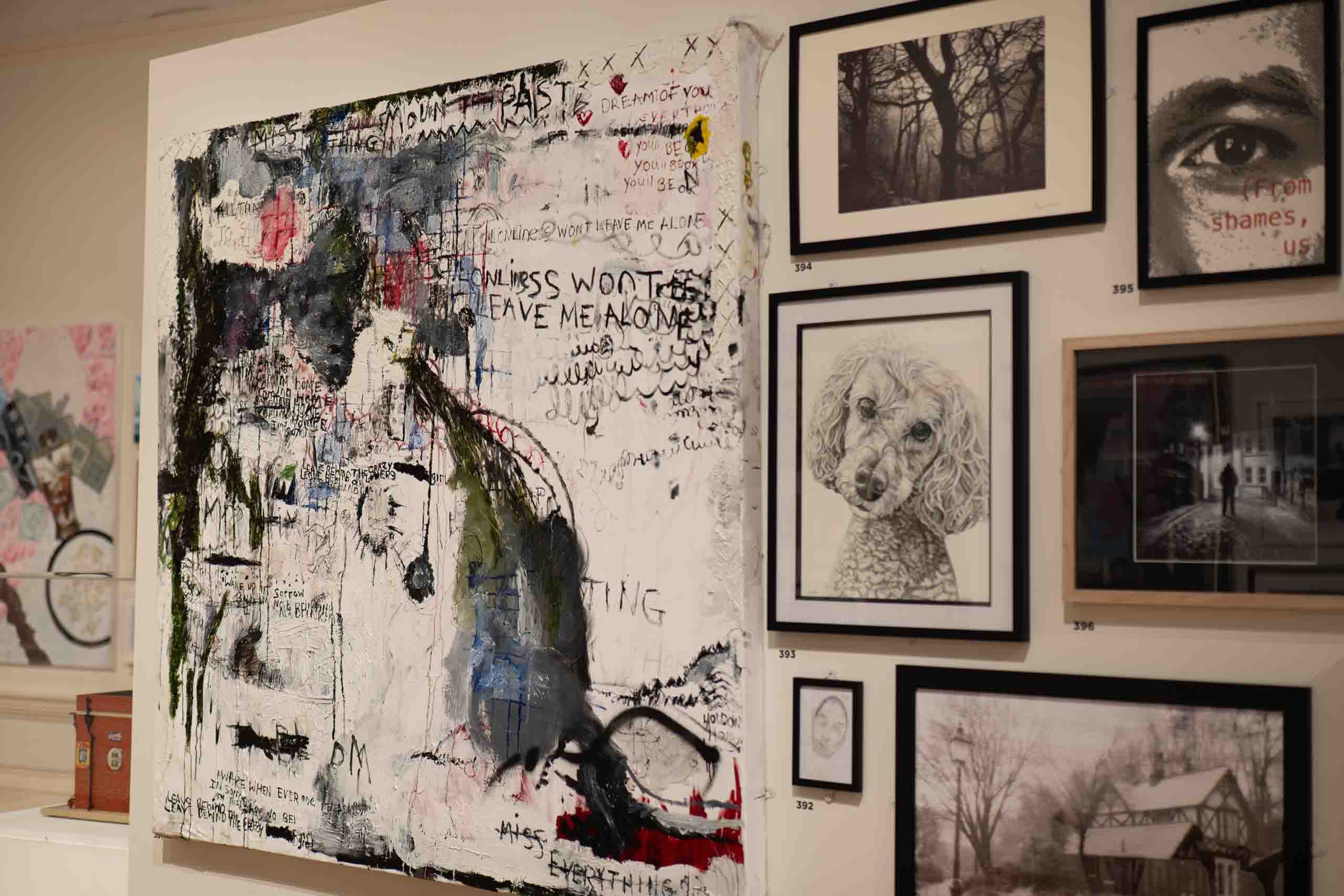 Harris Museum Open Exhibition 2026 — large textural mixed-media canvas with layered text fragments displayed alongside pencil drawings and photography prints