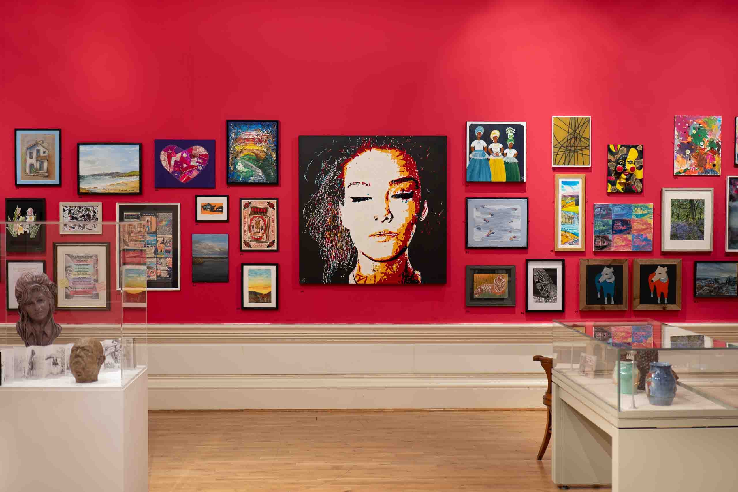 Harris Museum Open Exhibition 2026 Preston — red feature wall with large mosaic-style portrait as centrepiece, photographed by Bulldog Productions