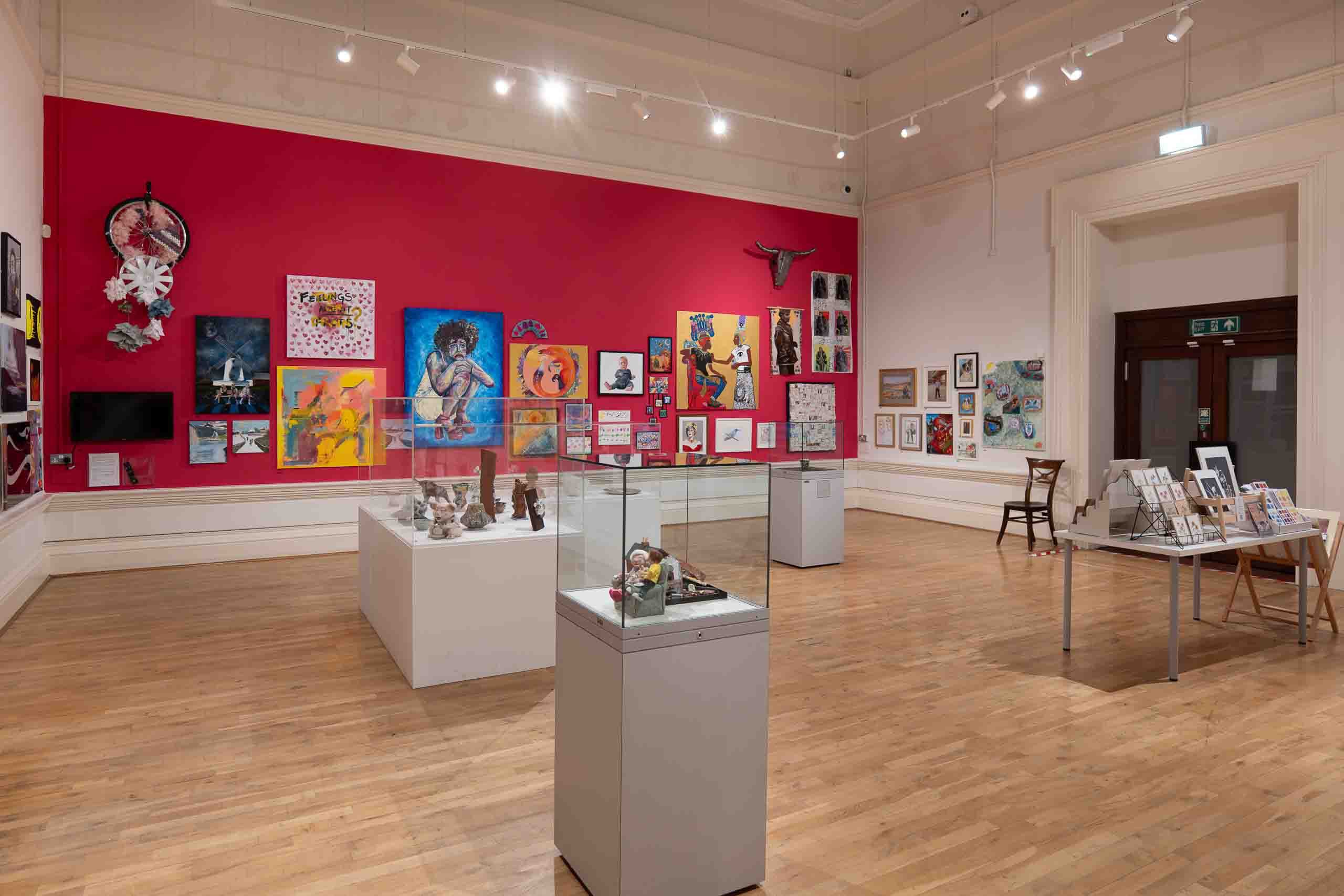 Harris Museum — red feature wall with Open Exhibition artworks